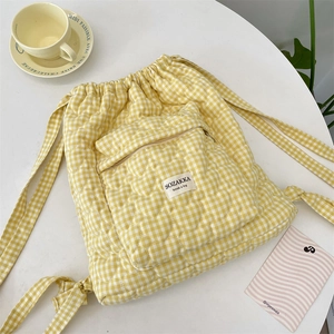 Detail of heart-shaped quilting on yellow checkered drawstring backpack for women