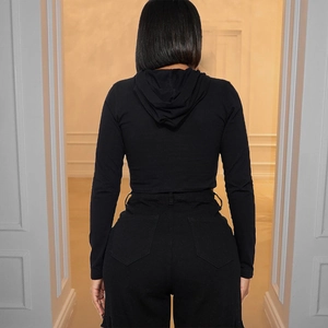 Back view of a black cropped hoodie with a hood, showing a slim fit and modern street style