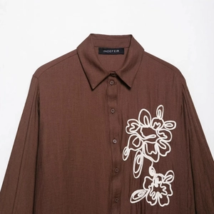 Brown long-sleeved shirt with white floral embroidery and coarse linen-like texture