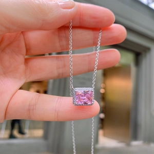 Silver halo necklace featuring a square pink zircon pendant held in hand for display
