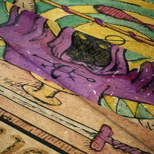 Macro shot of thick woven textile showing detailed fantasy wizard and sword print