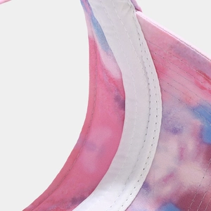 Detailed macro view of tie-dye visor fabric with precise double-stitching and sweatband