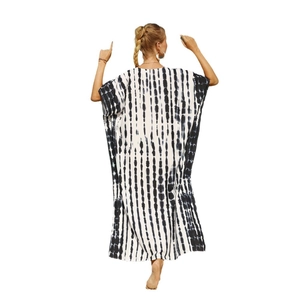 Women's long loose beach cover-up with black vertical tie-dye stripes on white fabric
