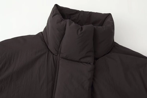 Close-up of the stand-up collar and quilted texture on a thick puffer jacket