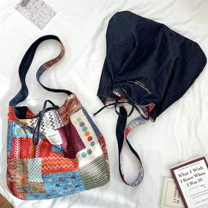 Detail of vintage bohemian patchwork tote and dark blue denim embroidered shoulder bag
