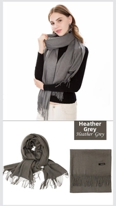 Detailed close-up of heather grey cashmere scarf showing soft texture and tassel fringe
