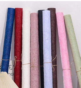 Rolls of handmade textured stone pattern paper in various colors with wrinkled surface