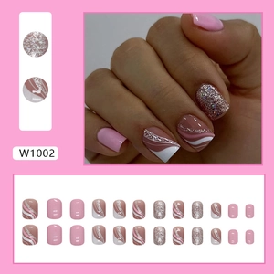 Pink and white striped press-on nails with glitter design for a sweet French manicure style