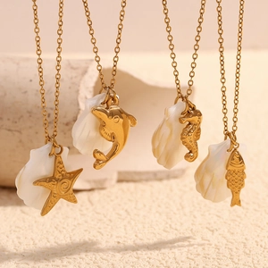 Detail of 18K gold starfish and dolphin ocean pendants with natural white shells