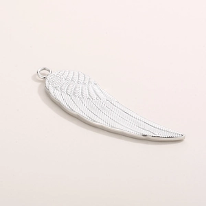 Detailed macro view of silver titanium steel wing pendant with fine feather textures