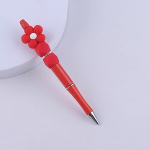 Detailed view of red silicone beaded pen featuring creative flower decor and metal tip
