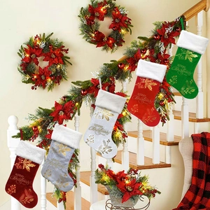Classic Christmas stockings with gold embroidery hanging on a festive decorated staircase
