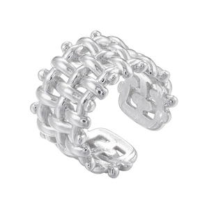 Detail of silver cuff ring featuring intricate woven mesh texture and beaded edges