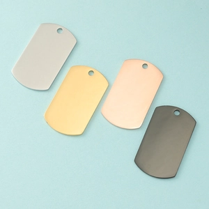 Polished stainless steel rectangular dog tags in four colors on blue background