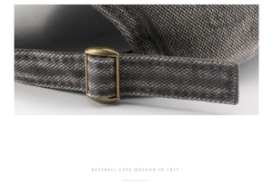 Macro shot of adjustable bronze metal buckle and washed twill cotton texture on grey cap
