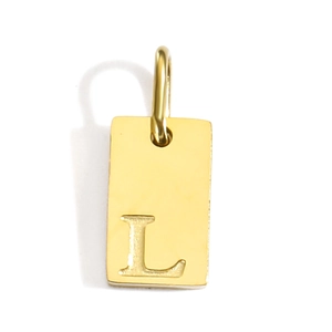 Close-up of a polished gold rectangular pendant featuring an engraved capital letter L