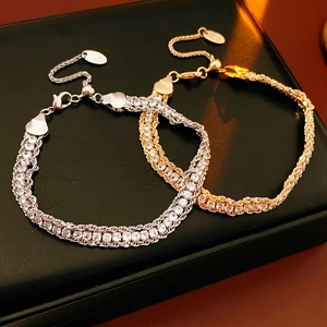 Detail of adjustable gold and silver chain bracelets with sparkling pavé zircon stones