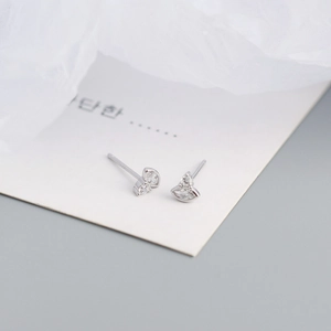 Macro shot of silver S925 earrings with marquise cubic zirconia on white display card