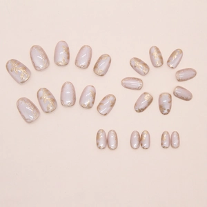 Detail of pearlescent pink press-on nails with 3D golden flower and vine embossing