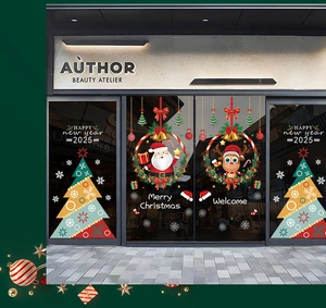 Close-up of Santa Claus and 2025 New Year window decals on a modern glass shop door