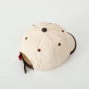 Detail view of cotton baseball cap with two-tone design and fine stitching details