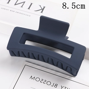 Detail view of 8.5cm navy blue matte rectangular hair claw clip with cutout design