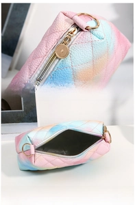 Detail of rainbow quilted crossbody bag featuring gold hardware and spacious interior