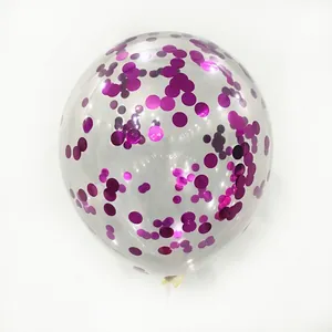 Macro detail of transparent latex balloon with metallic magenta sequins for party decor