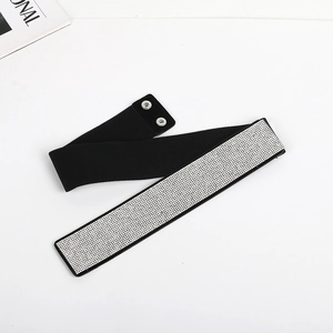 Detail showing the snap button closure and rhinestones on black elastic wide belt