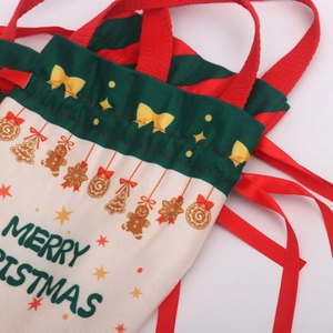 Detail of Christmas gift bag with Merry Christmas print and festive drawstring