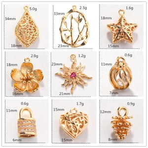 Macro detail of nine assorted gold jewelry pendants with dimensions and weights