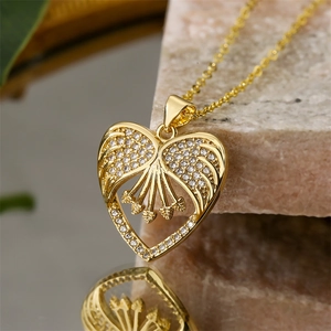 Macro shot of gold heart pendant with sparkling crystals on a textured stone base