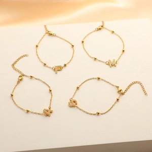 Elegant stainless steel initial letter charm bracelet with pavé rhinestones and gold beads