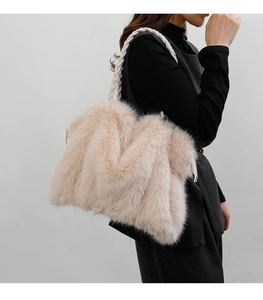 Detailed close-up of fluffy faux fur texture and woven shoulder strap on a plush tote bag
