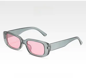 Detail view of retro square sunglasses with translucent gray frames and pink lenses