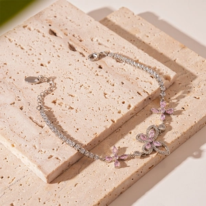Detailed macro of silver butterfly tennis bracelet with pink and white cubic zirconia