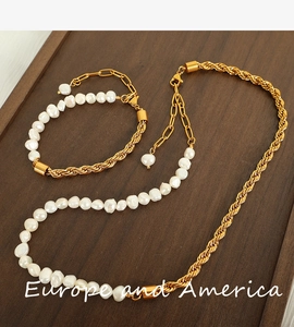 Detailed view of the baroque pearl and twisted gold chain necklace and bracelet set