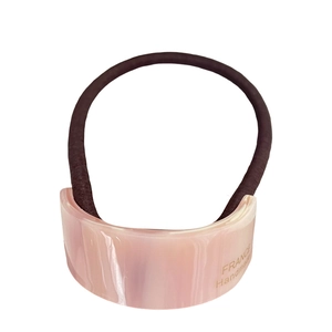 Pink marble pattern acetate hair tie with golden logo on dark brown elastic cord