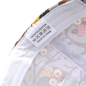 Close-up of baseball cap interior showing the 100% polyester fabric and washing label