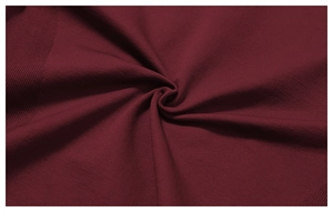 Macro shot of dark red seamless knitted ribbed fabric texture and soft drape detail