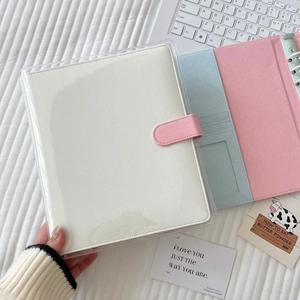 White PU leather photocard album with pink buckle and transparent PVC cover on white fabric