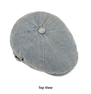 Top view of a vintage light blue washed denim newsboy cap with stitched panel structure