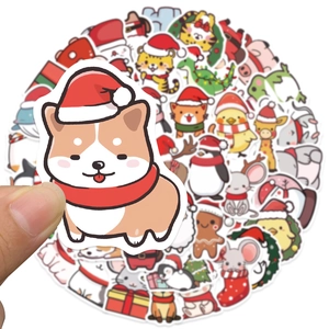 Hand holding a cute cartoon Corgi Christmas sticker from a waterproof animal gift set