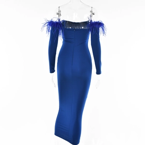 Rear view of tight blue long sleeve dress with low back and elegant blue feather shoulders