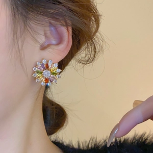 Elegant flower stud earrings with colorful zircon stones on model showing a 45-degree angle