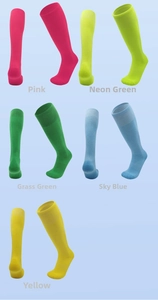 Detail of colorful children's football socks in pink, neon green, sky blue, and yellow