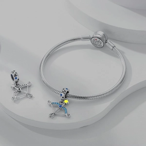 Macro detail of Sagittarius bow charm with blue zircon and Family IS FOREVER engraving