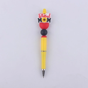 Close-up of yellow beaded pen featuring a Blessed MOM silicone sunflower charm