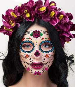 Close-up of a Day of the Dead face tattoo with colorful sugar skull floral patterns