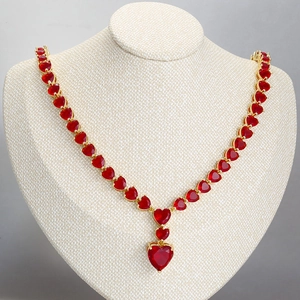 Elegant gold necklace with micro-pave red heart gemstones displayed on neck bust